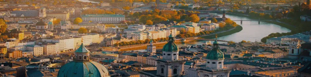 Panoramic view of Salzburg skyline historic city of Salzburg with Salzach river in beautiful golden evening light sky and colorful of autumn at sunset,Salzburger Land.
